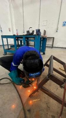 A person welding a metal object